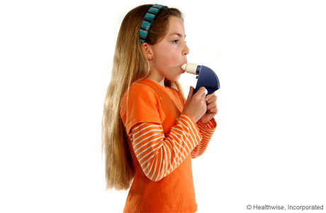 A child putting the peak flow meter mouthpiece in her mouth. A child putting the peak flow meter mouthpiece in her mouth.