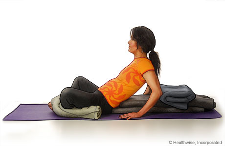 Picture of a woman in step six of reclining bound angle yoga pose Picture of a woman in step six of reclining bound angle yoga pose