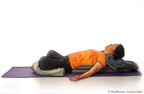 Picture of a woman in step seven of reclining bound angle yoga pose Picture of a woman in step seven of reclining bound angle yoga pose