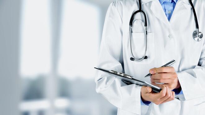 Doctor holding pen and clipboard